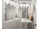 A clean, white bathroom with unique mirror and brushed gold fixtures at 8801 Rozetta Ct, Las Vegas, NV 89134