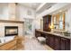 Elegant bathroom featuring a fireplace, soaking tub, and dual vanities at 8801 Rozetta Ct, Las Vegas, NV 89134