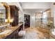 Elegant bathroom with dual sinks, granite countertops, and a large glass-enclosed shower at 8801 Rozetta Ct, Las Vegas, NV 89134