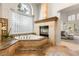 Spa-like bathroom featuring a soaking tub with jets and a cozy fireplace at 8801 Rozetta Ct, Las Vegas, NV 89134