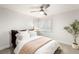 Bright bedroom features a ceiling fan, plush bed, and window with white shutters at 8801 Rozetta Ct, Las Vegas, NV 89134