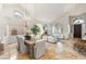 Elegant dining area with vaulted ceiling, decorative chandelier, and marble floors leading to formal living space at 8801 Rozetta Ct, Las Vegas, NV 89134