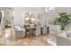 Bright dining room featuring a stylish chandelier, designer mirrors, and travertine flooring throughout at 8801 Rozetta Ct, Las Vegas, NV 89134