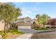 Attractive two-story home with a three-car garage, manicured lawn, and mature landscaping at 8801 Rozetta Ct, Las Vegas, NV 89134