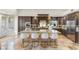 Modern kitchen with a large island, stainless appliances, and travertine flooring throughout at 8801 Rozetta Ct, Las Vegas, NV 89134
