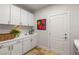 Functional laundry room with ample white cabinetry, countertops, and a convenient sink at 8801 Rozetta Ct, Las Vegas, NV 89134