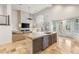 Bright open-concept living space with modern island and French doors to the backyard at 8801 Rozetta Ct, Las Vegas, NV 89134