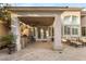 Covered patio with outdoor kitchen, seating area, and landscaped backyard, great for entertaining at 8801 Rozetta Ct, Las Vegas, NV 89134