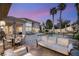 Outdoor pool area with a luxurious seating area and palm trees, perfect for relaxing and entertaining at 8801 Rozetta Ct, Las Vegas, NV 89134