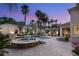 Backyard pool area features a hot tub, waterfall feature, lounge chairs, and lush tropical foliage at 8801 Rozetta Ct, Las Vegas, NV 89134