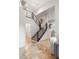 Spacious foyer with a modern staircase design, travertine floors, and ample natural light at 8801 Rozetta Ct, Las Vegas, NV 89134