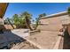 The backyard features a patio area, mature landscaping, and a large dirt area at 9044 Crimson Clover Way, Las Vegas, NV 89134