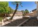 The backyard features a patio area, mature landscaping, and a large dirt area at 9044 Crimson Clover Way, Las Vegas, NV 89134