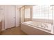 Bathroom with a soaking tub, shower, and tile flooring at 9044 Crimson Clover Way, Las Vegas, NV 89134
