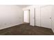 View of a well-lit bedroom with carpet flooring and closet doors at 9044 Crimson Clover Way, Las Vegas, NV 89134