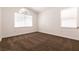 Bedroom with neutral carpet and two bright windows at 9044 Crimson Clover Way, Las Vegas, NV 89134