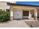 Welcoming front entryway with a covered porch and double doors, complemented by desert landscaping at 9044 Crimson Clover Way, Las Vegas, NV 89134