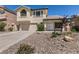 Charming two-story home featuring a tile roof, attached two-car garage, and desert rock landscaping at 9044 Crimson Clover Way, Las Vegas, NV 89134