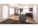 View of the kitchen featuring tiled floors, grey cabinets and an island at 9044 Crimson Clover Way, Las Vegas, NV 89134