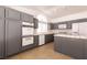 Spacious kitchen featuring gray cabinets, an island, and modern appliances at 9044 Crimson Clover Way, Las Vegas, NV 89134