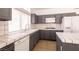 Kitchen featuring grey cabinets, white appliances, tile countertops, and ample countertop space at 9044 Crimson Clover Way, Las Vegas, NV 89134