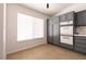 Close-up view of kitchen area with white appliances, grey cabinets, and a window at 9044 Crimson Clover Way, Las Vegas, NV 89134