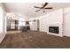 Open-concept living room featuring a fireplace and kitchen with gray cabinets and modern appliances at 9044 Crimson Clover Way, Las Vegas, NV 89134