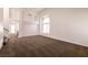 Bright and airy living room with a large arched window and neutral carpet, perfect for comfortable living at 9044 Crimson Clover Way, Las Vegas, NV 89134