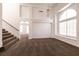 Open-concept living room with staircase access, neutral walls, and carpet, creating a seamless flow at 9044 Crimson Clover Way, Las Vegas, NV 89134