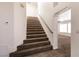 Carpeted staircase leading to the second floor, adjacent to the open living area at 9044 Crimson Clover Way, Las Vegas, NV 89134