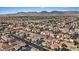 Wide aerial view of a residential community with mountain views and neatly arranged homes with well-maintained landscaping at 9284 Lopseed Ct, Las Vegas, NV 89149