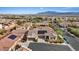 Overhead view of homes in a neighborhood featuring solar panels on roofs and manicured lawns, close to mountain views at 9284 Lopseed Ct, Las Vegas, NV 89149