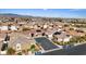 Residential area aerial view showcasing homes with solar panels and landscaping, set against a mountain backdrop at 9284 Lopseed Ct, Las Vegas, NV 89149