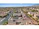 Expansive aerial view of a neighborhood featuring desert landscaping and solar panels with mountain views at 9284 Lopseed Ct, Las Vegas, NV 89149