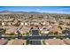 Expansive aerial view of a neighborhood featuring desert landscaping and solar panels with mountain views at 9284 Lopseed Ct, Las Vegas, NV 89149