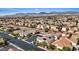 Expansive aerial view of a neighborhood featuring desert landscaping and solar panels with mountain views at 9284 Lopseed Ct, Las Vegas, NV 89149
