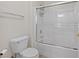 Bathroom featuring modern toilet, white vanity, and tiled shower with glass doors at 9284 Lopseed Ct, Las Vegas, NV 89149