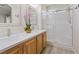 Bathroom featuring double sinks, modern fixtures, and a glass-enclosed shower with white tile at 9284 Lopseed Ct, Las Vegas, NV 89149