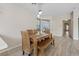 Dining room with modern furniture, wood floors, and natural light at 9284 Lopseed Ct, Las Vegas, NV 89149