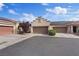 Three-car garage with a well-maintained driveway and desert landscaping with solar panels at 9284 Lopseed Ct, Las Vegas, NV 89149