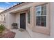 Welcoming front entrance with secure door, neutral stucco, and a planter box for added charm at 9284 Lopseed Ct, Las Vegas, NV 89149