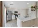 Renovated kitchen with white cabinets, quartz countertops, stainless steel appliances and wood-look floors at 9284 Lopseed Ct, Las Vegas, NV 89149