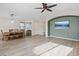 Open living area with wood-look tile floors, dining table and media niche at 9284 Lopseed Ct, Las Vegas, NV 89149