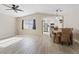 Open concept living room featuring hardwood floors and a view into the bright white kitchen at 9284 Lopseed Ct, Las Vegas, NV 89149