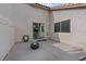 Outdoor patio featuring a sleek fire pit, a sliding glass door, and a well-maintained white fence for privacy at 9284 Lopseed Ct, Las Vegas, NV 89149