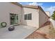 Back patio featuring a cozy fire pit, a sliding door, and a white fence, creating a private outdoor space at 9284 Lopseed Ct, Las Vegas, NV 89149