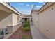 Side yard features rock landscaping and a paved walkway, creating a clean and modern aesthetic at 9284 Lopseed Ct, Las Vegas, NV 89149