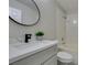 Bright bathroom featuring a sleek vanity with a black faucet and a shower-tub combination at 9436 Mount Cash Ave # 101, Las Vegas, NV 89129