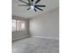 Bright bedroom with tile flooring, a ceiling fan, and a view of the backyard at 9436 Mount Cash Ave # 101, Las Vegas, NV 89129