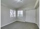 Cozy bedroom with carpet, two windows, and closet with sliding doors at 9436 Mount Cash Ave # 101, Las Vegas, NV 89129